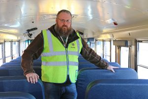 Indian River School District Unit President Jason Harvey, shown here on a district bus, said that having a new contract is like a "gigantic weight lifted off our shoulders." 