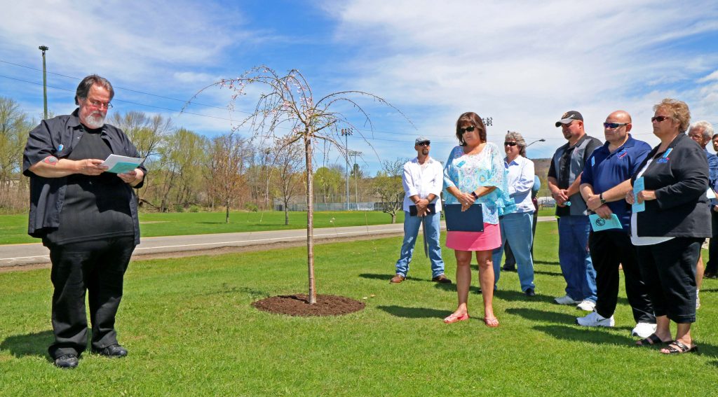 Central Region Safety and Health Committee Chair Joe Miceli, left, reads the name of CSEA member Donald F. Schultz II, who died Oct. 29, 2016, from on-the-job injuries during the region’s Workers’ Memorial Day tree planting ceremony in Oneonta. More than 50 CSEA members attended the ceremony, including Central Region President Colleen Wheaton, region Treasurer Kathy Zabinski, region 2nd Vice President Ken Greenleaf and region 3rd Vice President Casey Walpole.