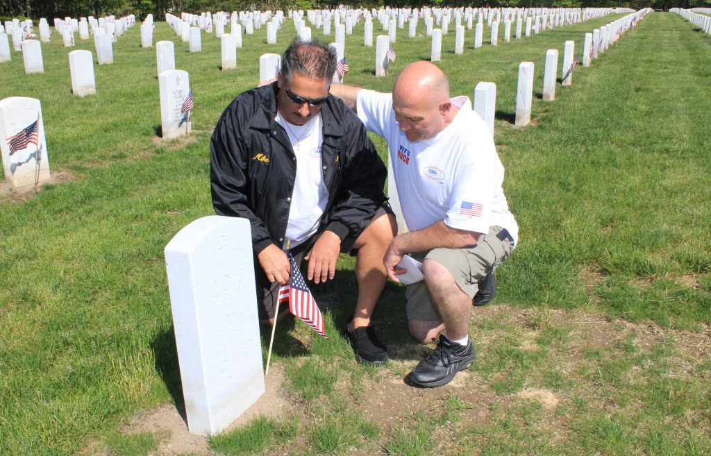 Long Island Region Veterans Committee member Mike Giglio, left, places a flag at his parents’ grave as Suffolk Retirees Local activist Bill Parente comforts him. Members placed flags at the graves of CSEA members, relatives of members and others affiliated with our union during the Veterans Committee’s annual Memorial Day ceremony at Calverton National Cemetery.
