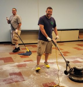 Yonkers School District Unit members Christopher Gonzalez, left, and Rosario Cioffi strip floors at Saunders Trades and Technical High School.