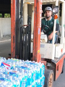Roberto Clemente State Park worker Jason Anglada helps to load and unload water pallets that are being sent to assist the people of Puerto Rico.