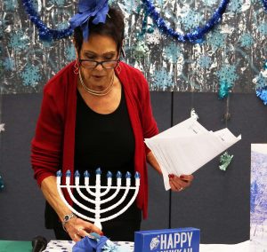 Eileen Moskowitz tells the story of Hanukkah before she lights the menorah.