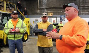 Clifton Park Highway Unit member Dave Pettis, right, makes an observation about the equipment as co-workers, from left, Andy Jerome and Cory Schumacher listen.