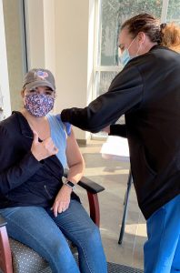 Myrian Benton, a patient care technician at Ellenville Regional Hospital, receives the COVID vaccine on Dec. 28, 2020. (Photo by Debbie Briggs, Ellenville Regional Hospital)