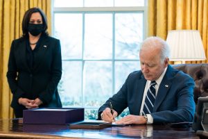 President Joe Biden signs the American Rescue Plan into law on March 11, 2021 as Vice President Kamala Harris looks on. (Photo by The White House)