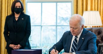 President Joe Biden signs the American Rescue Plan into law on March 11, 2021 as Vice President Kamala Harris looks on. (Photo by The White House)