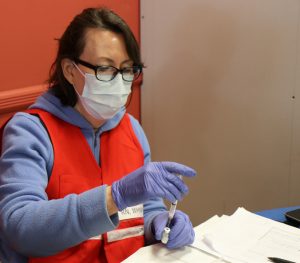 Putnam County Unit member Jean Ralston, a public health nurse at the Putnam County Department of Health, prepares vials of Pfizer vaccine during a vaccine clinic in Brewster.