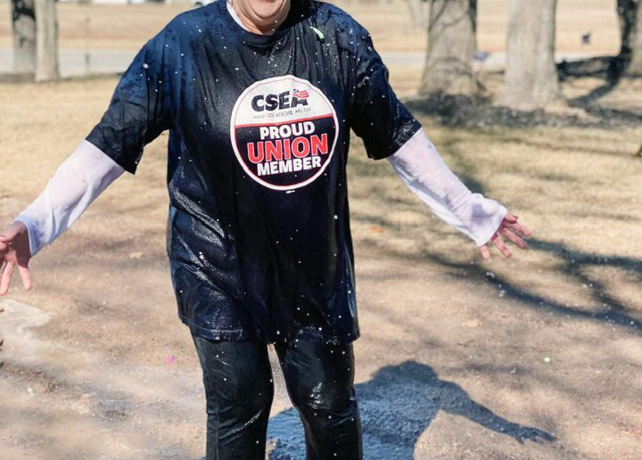 Cape Vincent Correctional Facility Local President Jolene Radley, who is consistently one of the CSEA Central Region’s top fundraisers for the Polar Plunge, recently took her plunge virtually by taking on some water balloons and cold buckets of water in balmy 28-degree, windy weather. See Page 19 for more about how CSEA members are continuing to support the Special Olympics during a year when Polar Plunges have been virtual or modified. (Photo provided).