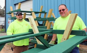 As residents return to outdoor activities, the condition of parks, bike paths, trails and fields becomes a priority for public works and parks and recreation staff across the state. In the Capital Region, Town of Rotterdam Parks and Recreation staff built new picnic benches to be placed in parks throughout the town. Rotterdam Parks and Recreation employees Justin D’Alessandro, left, and Chad Propper load new picnic benches onto a truck to be delivered to town parks.