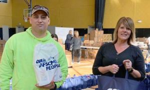 In this 2020 file photo, Schenectady County Public Works employee John Roth left, and CSEA Schenectady County Office Unit President Katie Soule help package groceries for families in need.