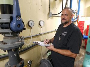 Person_maintaining_pool_pump_room