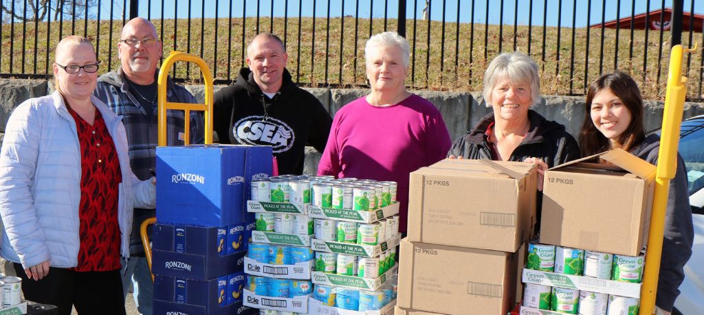 Southern Region state correctional facility local officers worked together to coordinate an overwhelmingly successful Thanksgiving food drive for veterans who use the Castle Point VA Medical Center food pantry. Pictured are, from left, Sullivan Correctional Facility Local President Nikki Wallace, Bedford Hills Correctional Facility Local Treasurer Chris Martin, Bedford Hills Correctional Facility Local President George Beekman, Ulster Correctional Facility Local President Linda White, Woodbourne Correctional Facility Local President Bonnie Huebsch, and Juliana Martinez, Huebsch’s granddaughter.