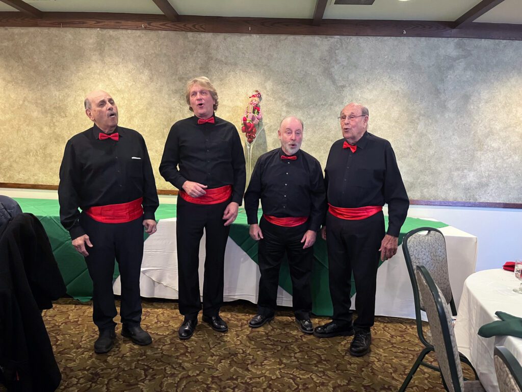 Four_men_standing_and_singing