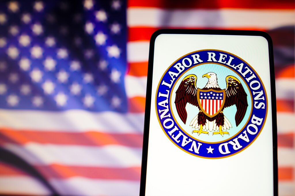 National Labor Relations Board (NLRB) logo_on_smartphone_U.S._flag_in_background.