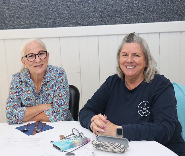 Two_women_sitting_at_table