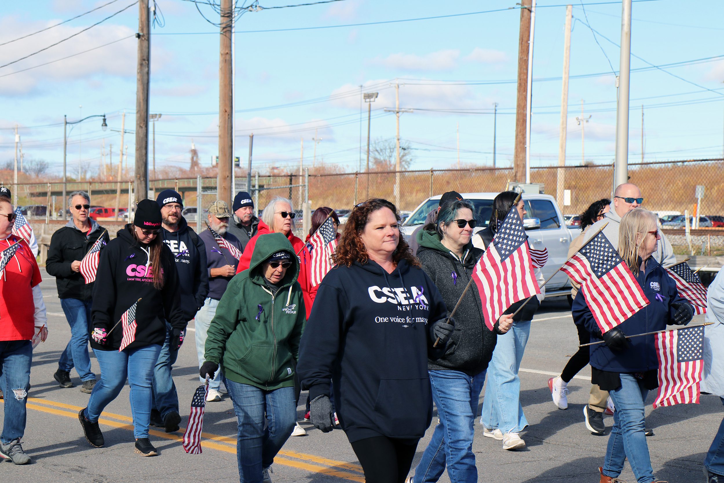 Image_of_people_walking_holding_US_flags