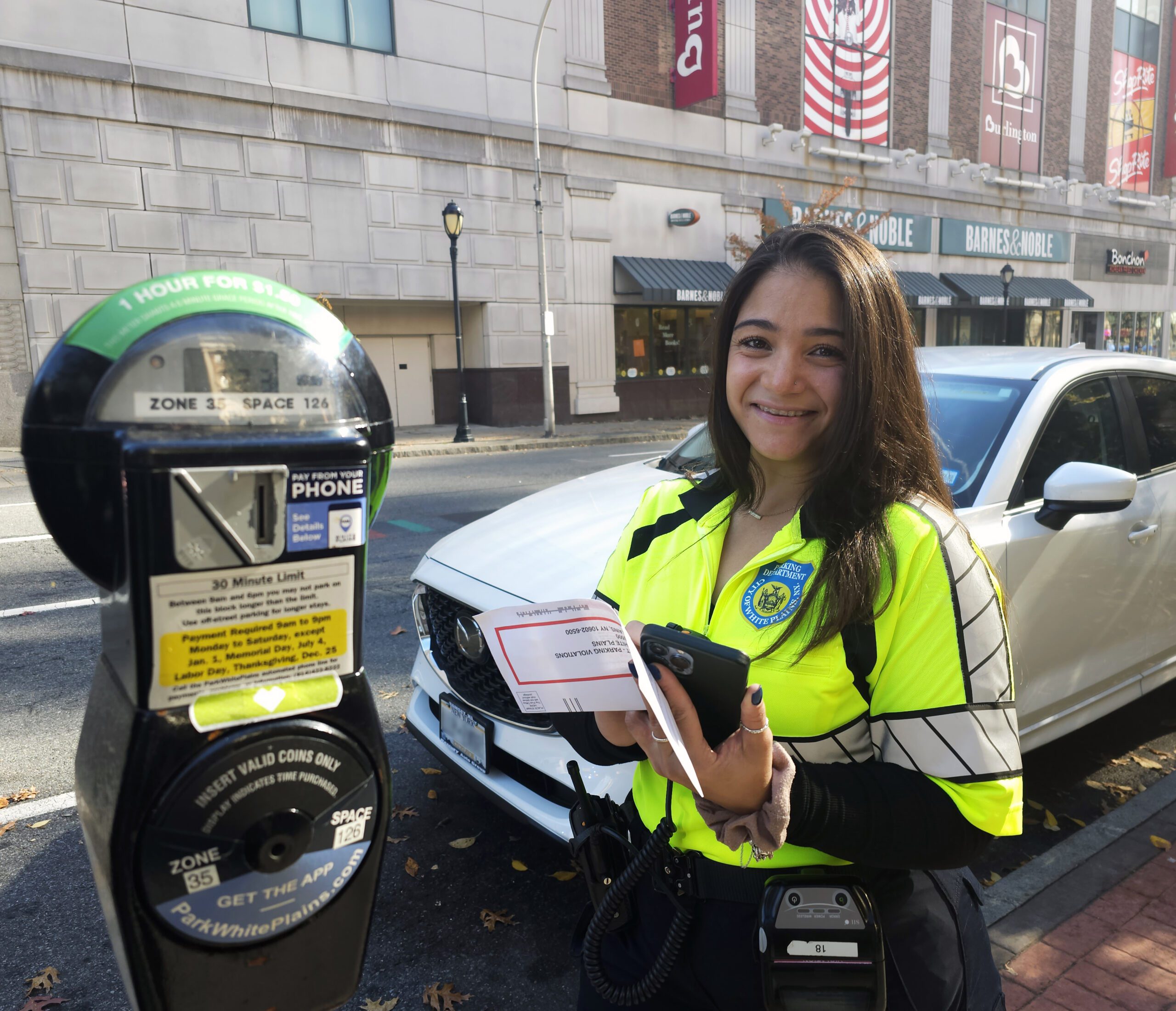 Image_of_woman_outdoors_next_to_car_and_parking_meter
